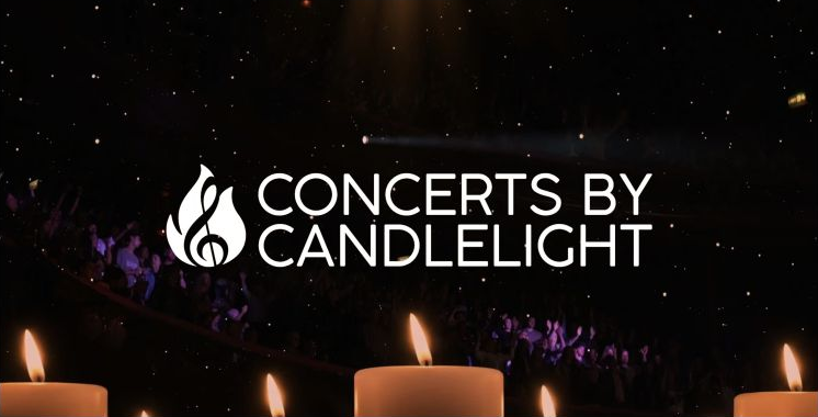 Concert performers on a candlelit stage